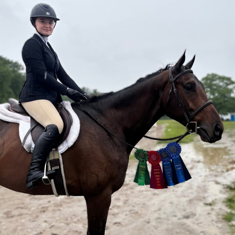 perfect timing with student and ribbons at horse show 